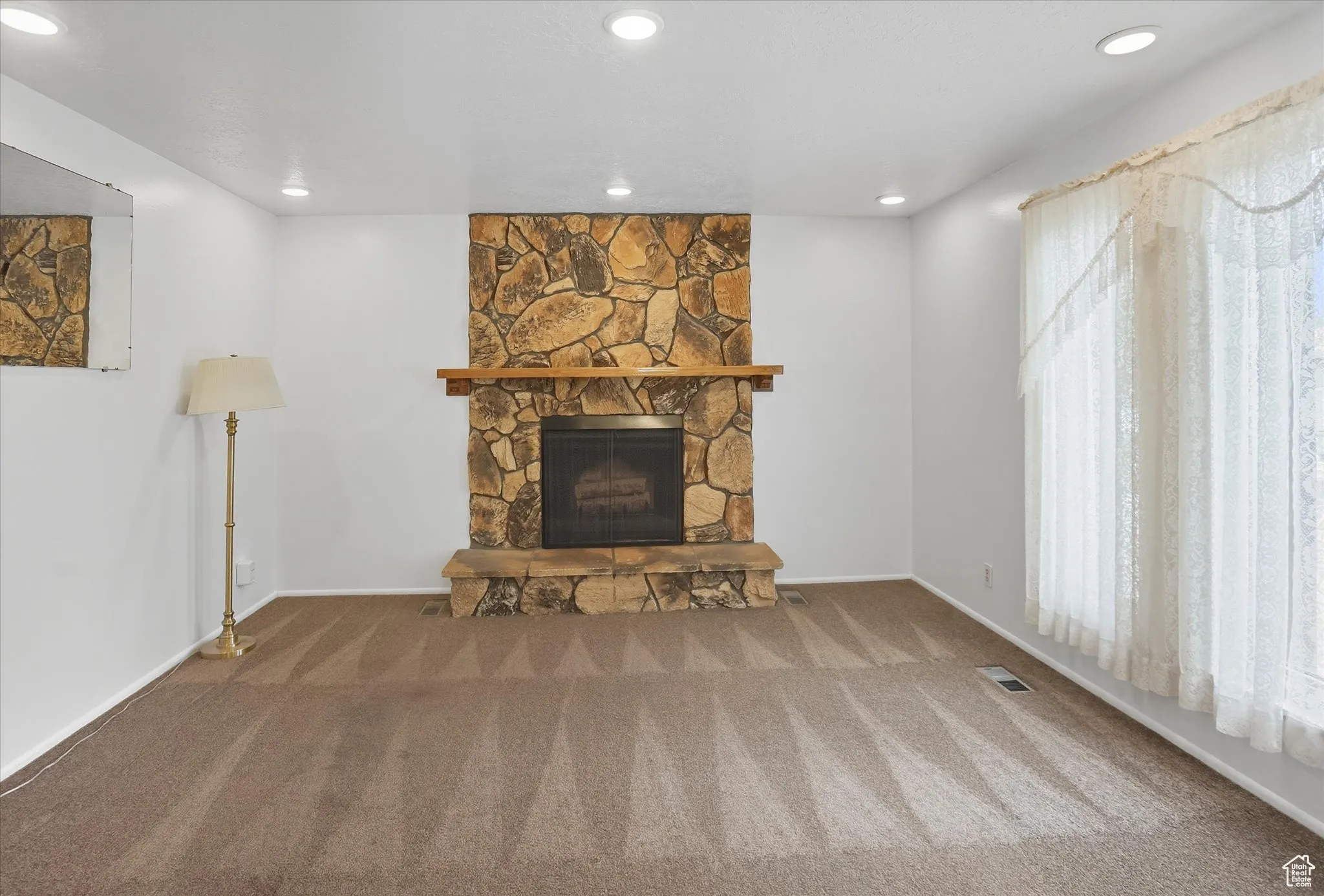 Living room with a fireplace, carpet