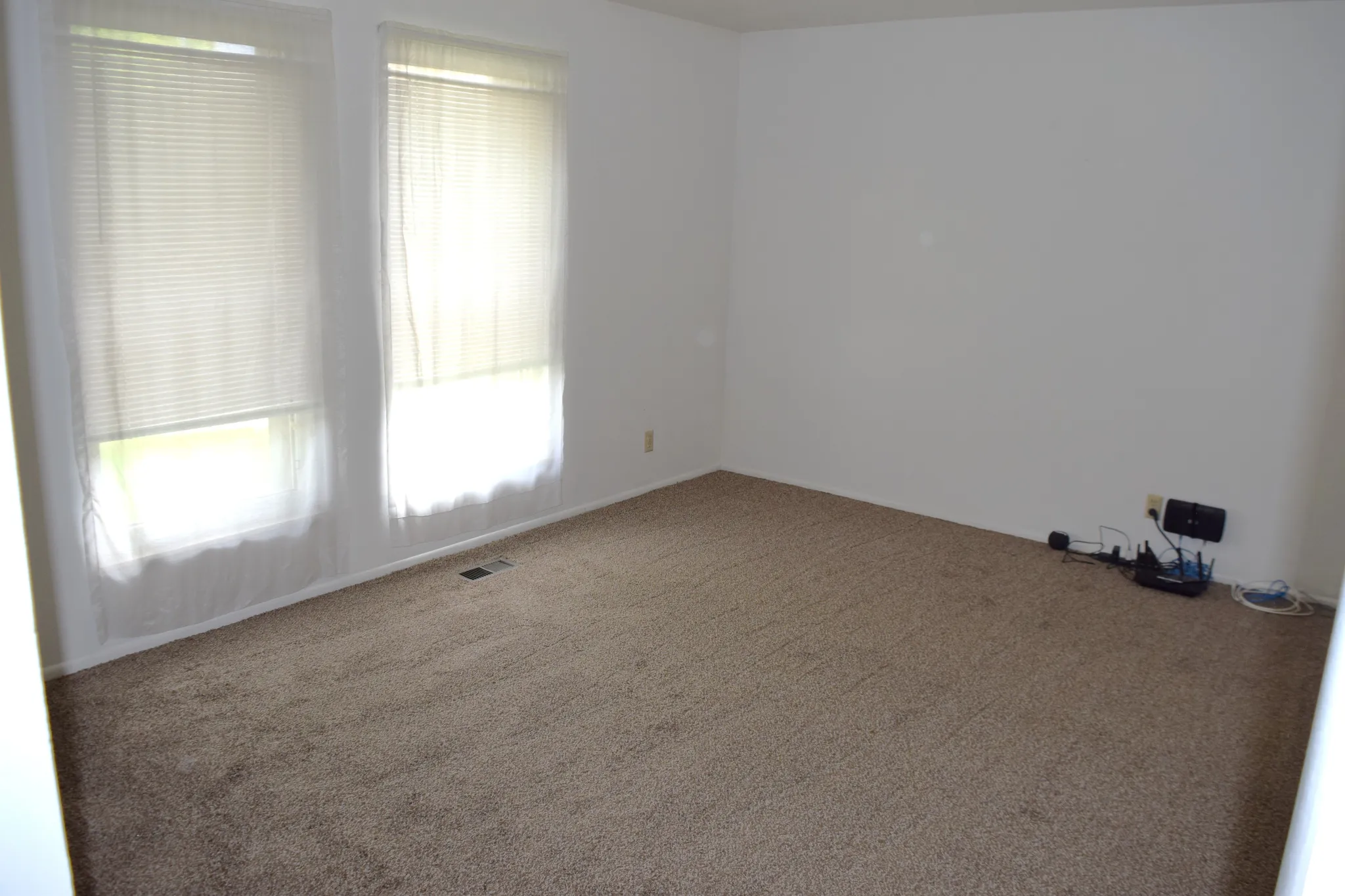 Empty room featuring carpet flooring and baseboards