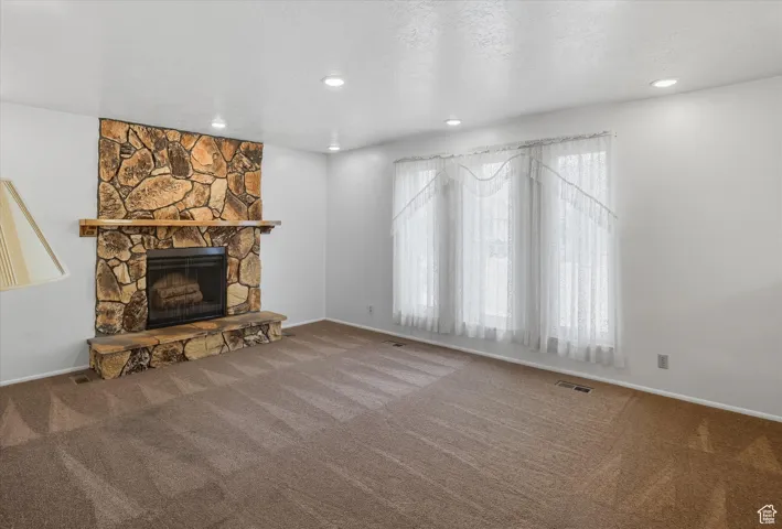 Living room with a fireplace, carpet