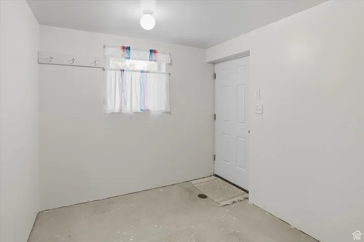 Spare room with unfinished concrete floors