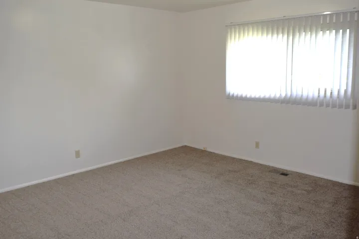Unfurnished room featuring carpet flooring and baseboards