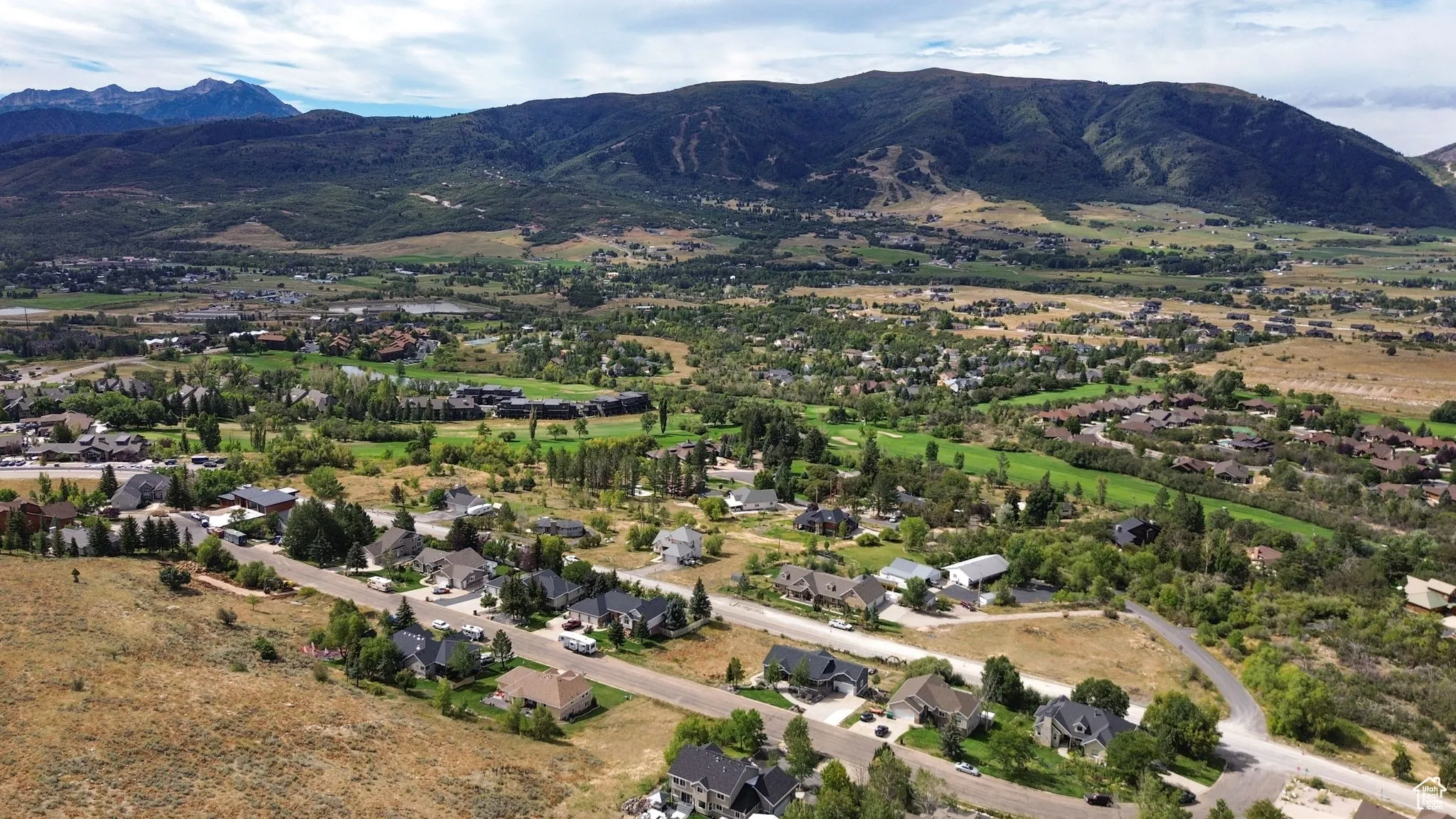 View of property location with mountains and nearby suburban area