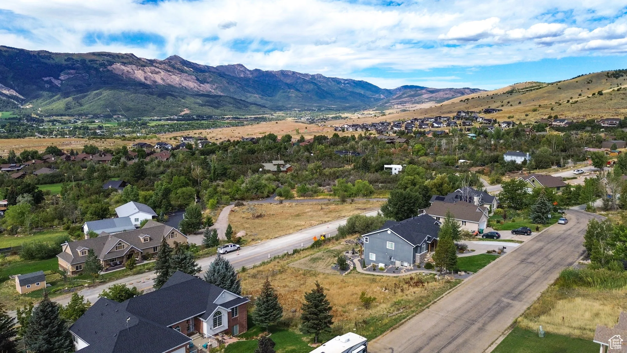 Aerial perspective of suburban area with a mountain backdrop