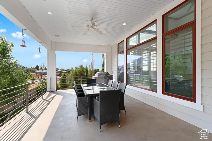 View of patio with a ceiling fan, outdoor dining area, and a grill