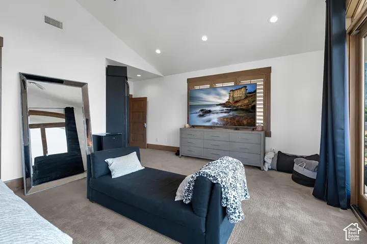 Bedroom featuring recessed lighting, carpet flooring, and high vaulted ceiling