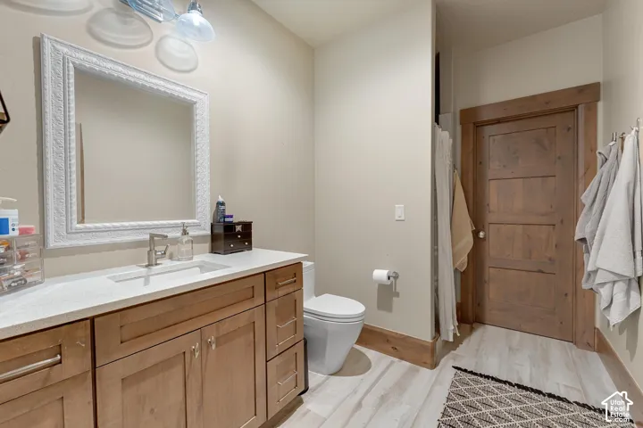 Full bathroom featuring vanity and light wood-style flooring