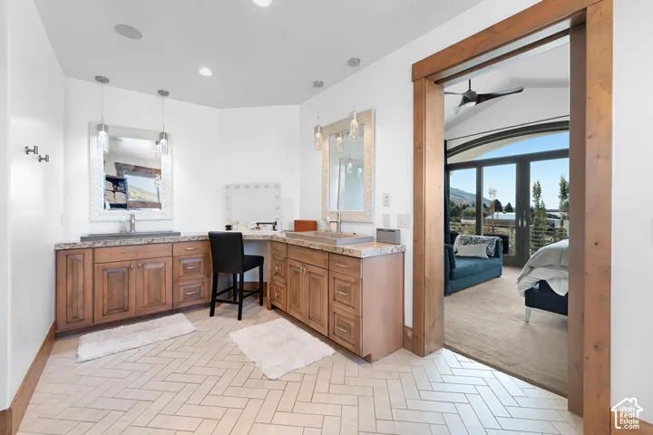 Ensuite bathroom with double vanity, a ceiling fan, and recessed lighting