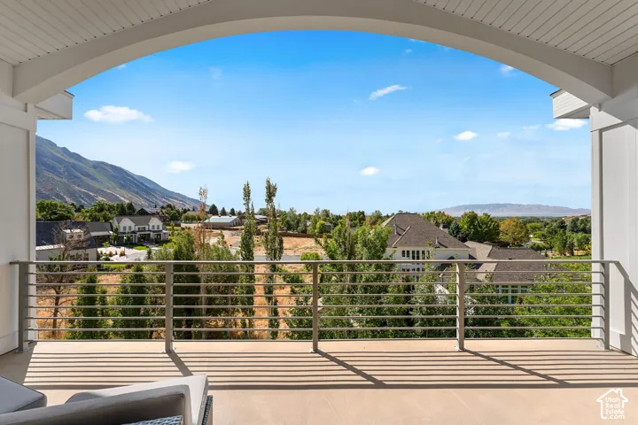 Balcony featuring a residential view and a mountain view