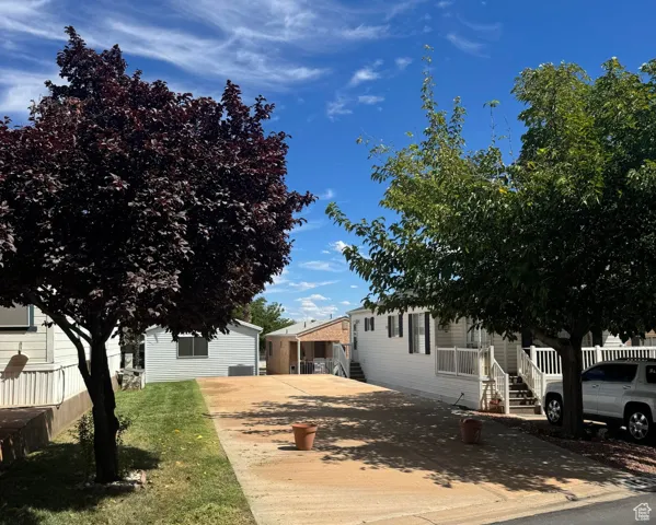 View of side of home featuring concrete driveway