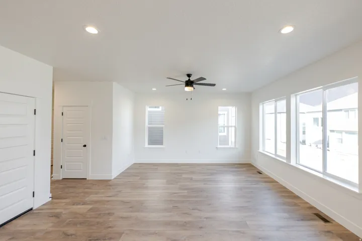 Unfurnished room with light wood-style flooring, ceiling fan, and recessed lighting