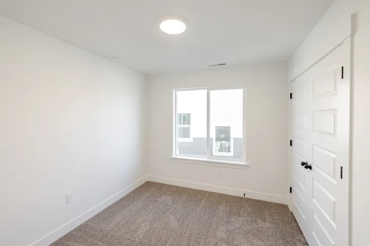 Spare room with baseboards and carpet flooring