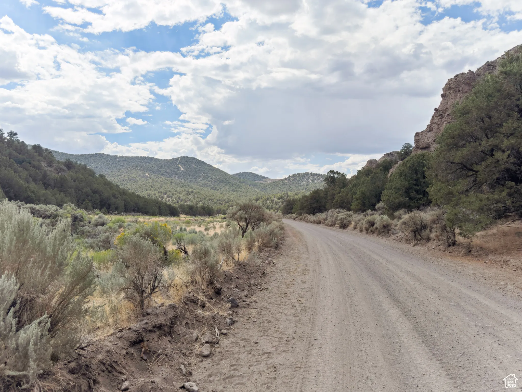 View of dirt / gravel road with a mountain view