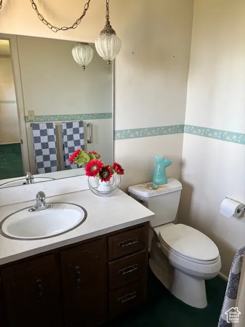 Half bath featuring vanity and toilet