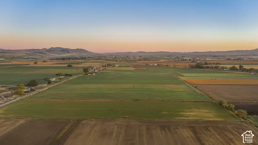 Aerial view at dusk of a view of countryside, a mountain view, and agricultural plots