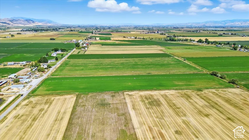 Aerial view of sparsely populated area featuring mountains and large plots for crops
