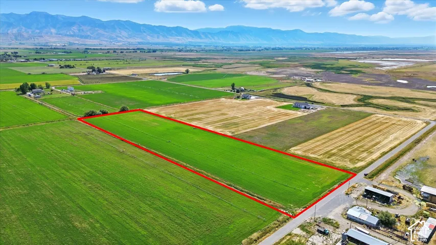 Overview of rural landscape with mountains and property parcel outlined