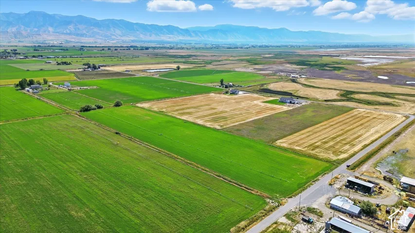 View of rural area featuring a mountainous background and large plots for crops