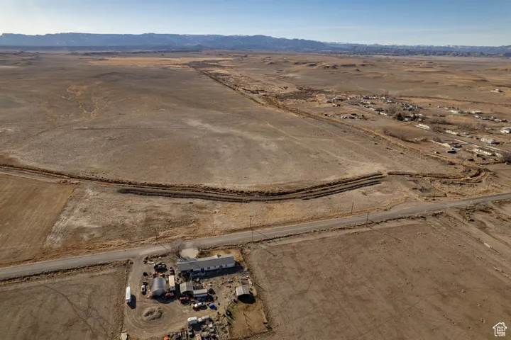 Aerial overview of property's location featuring rural landscape and a mountainous background