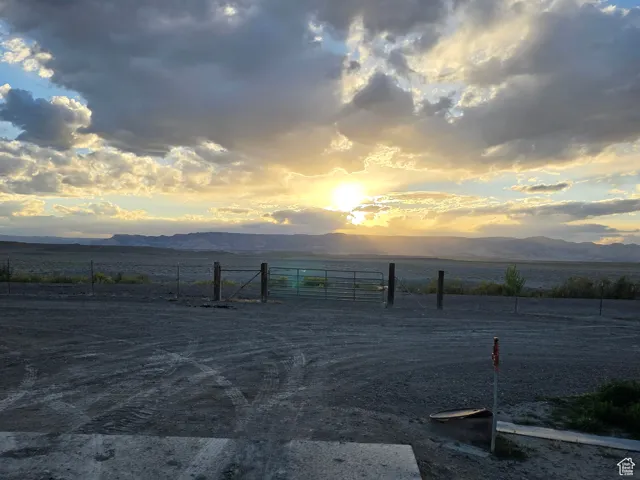 View of road featuring a view of rural / pastoral area, a mountain view, and a gate