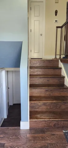 Staircase featuring wood finished floors