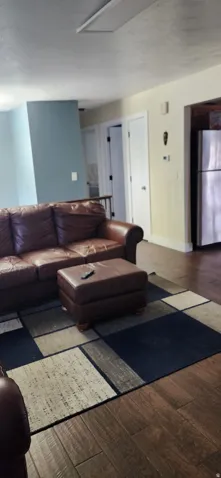 Living area with wood finished floors and baseboards