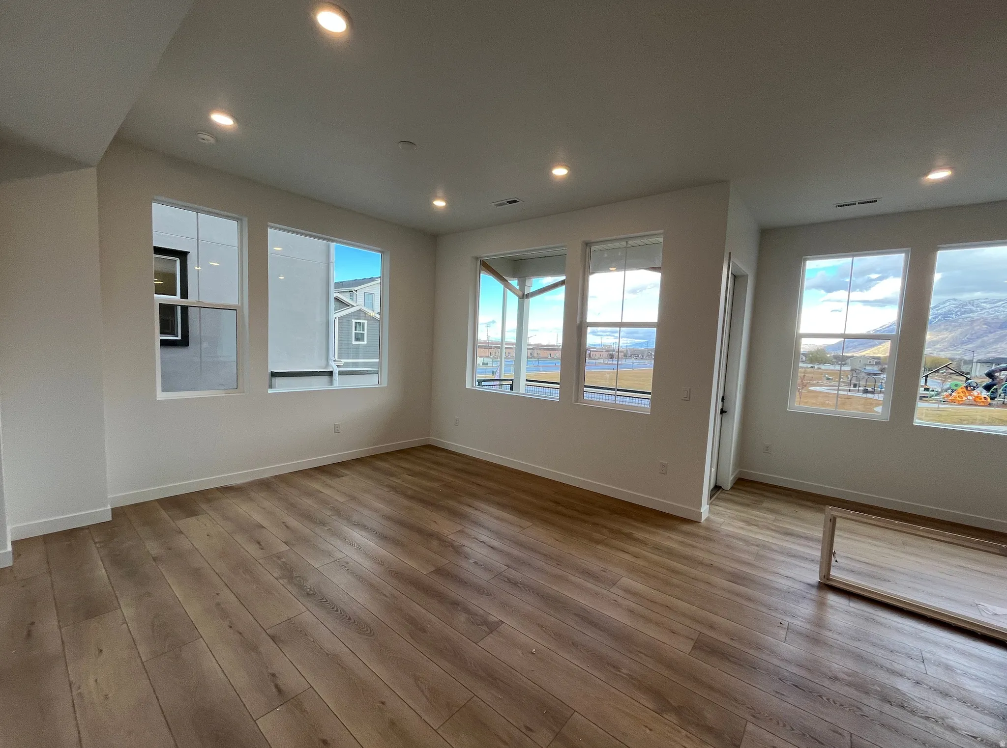 Unfurnished living room featuring light wood-style floors and recessed lighting