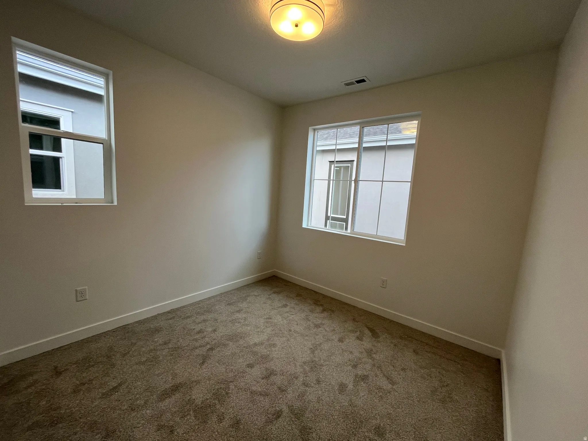 Unfurnished room with carpet flooring and baseboards