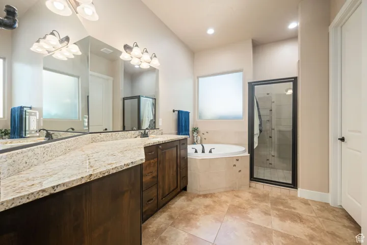 Full bath with vanity, a garden tub, a stall shower, light tile patterned floors, and recessed lighting