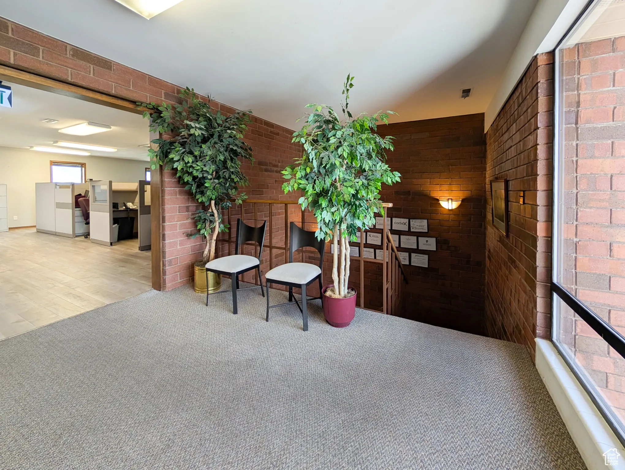 Lobby featuring brick wall