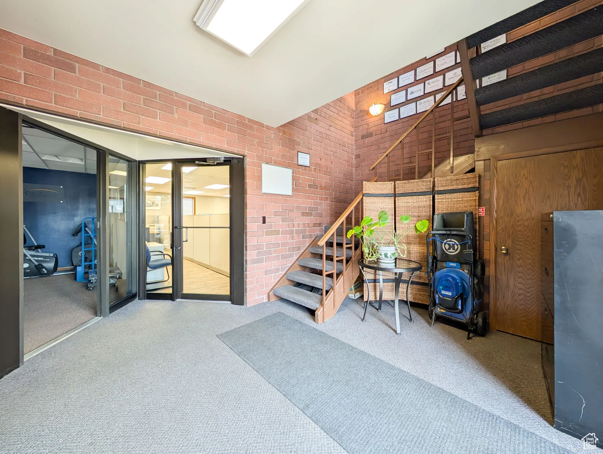Staircase with brick wall and carpet