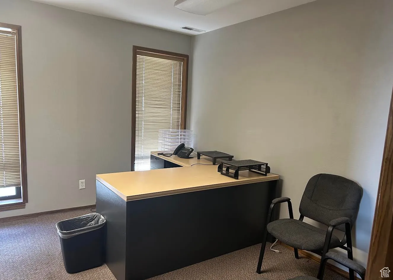 Office space featuring dark carpet
