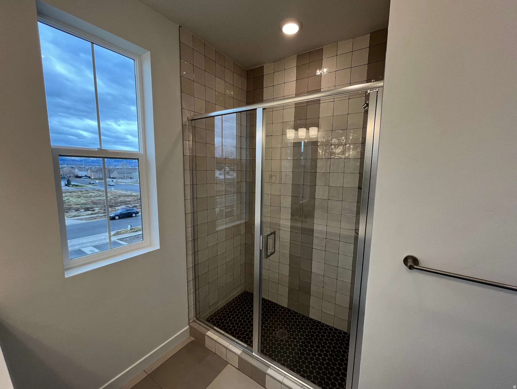 Full bath featuring a stall shower, tile patterned floors, and recessed lighting