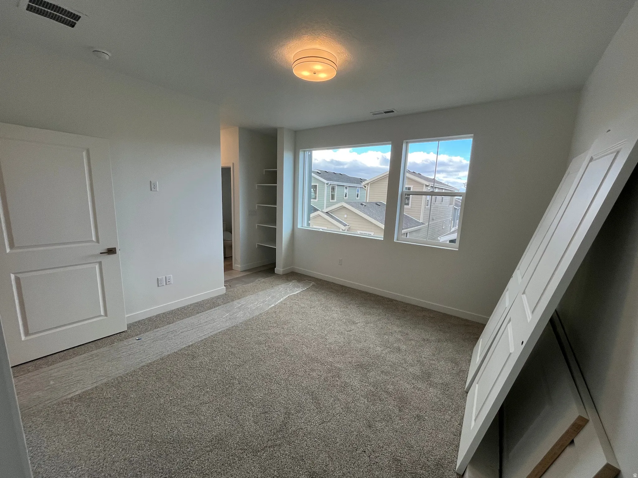 Unfurnished bedroom featuring carpet floors and baseboards