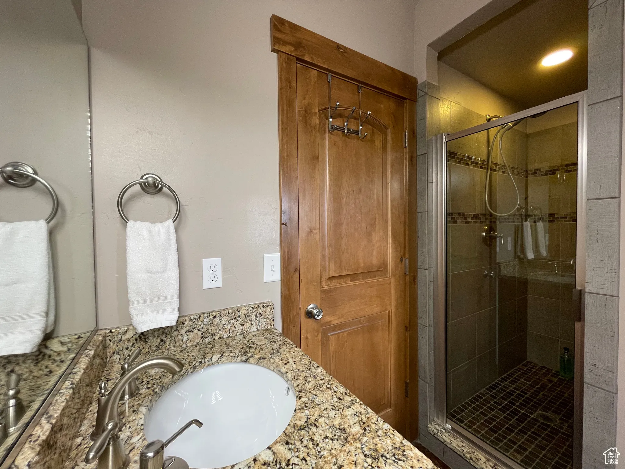Bathroom featuring vanity and a stall shower