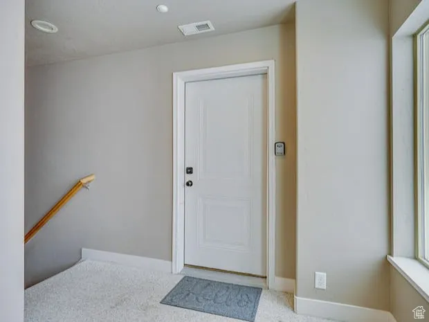 Doorway to outside with baseboards and recessed lighting