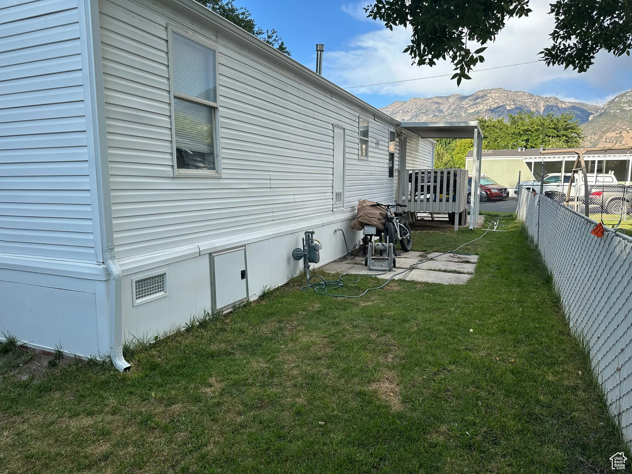 View of side of property featuring a deck with mountain view