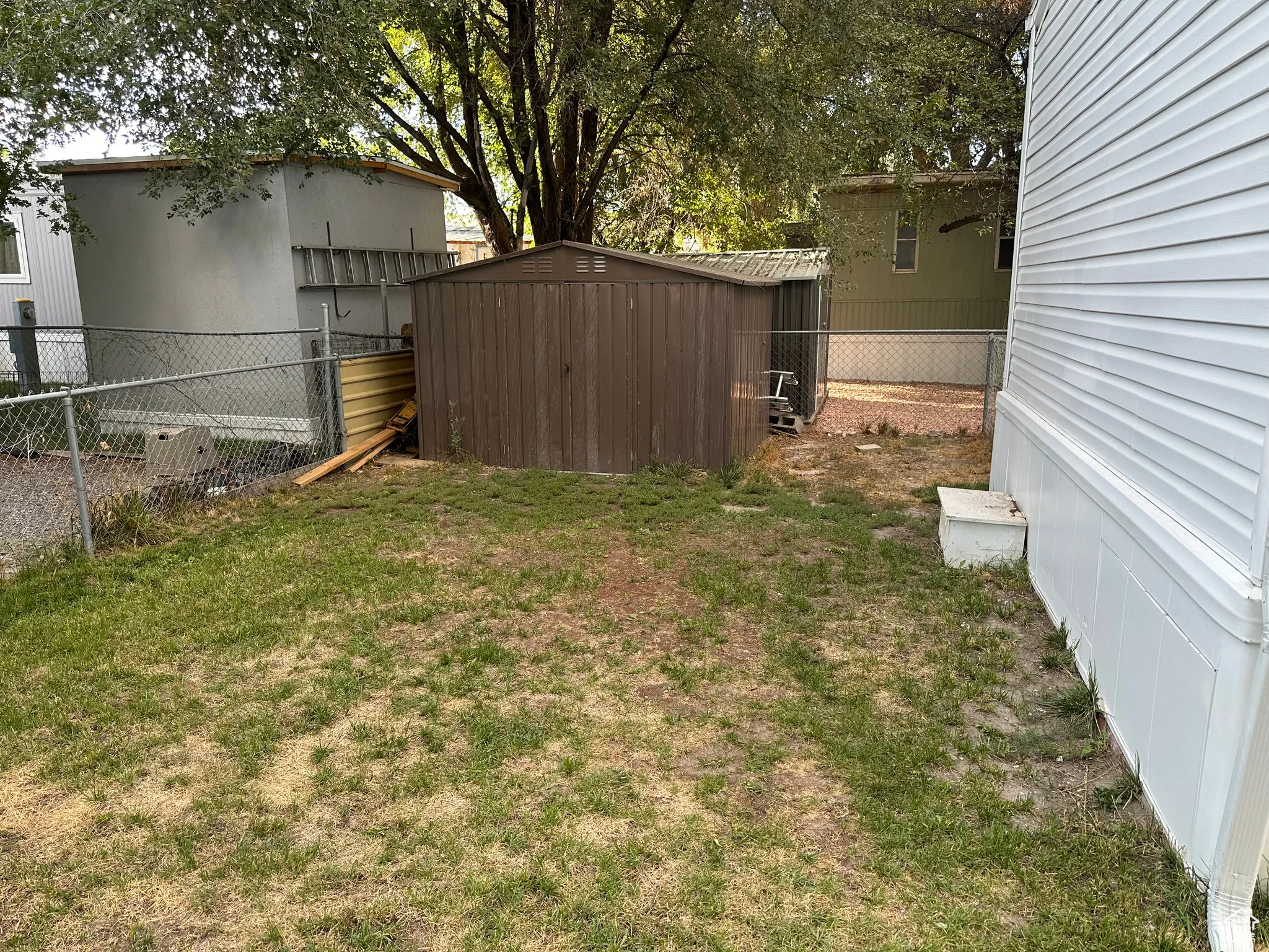 View of yard with a storage unit