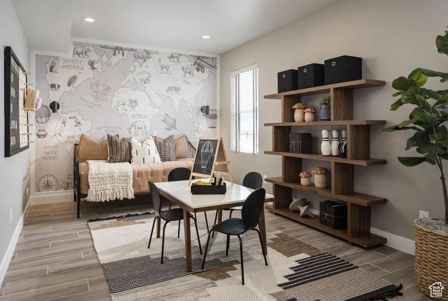 Sitting room with an office area, wood tiled floors, an accent wall, and recessed lighting