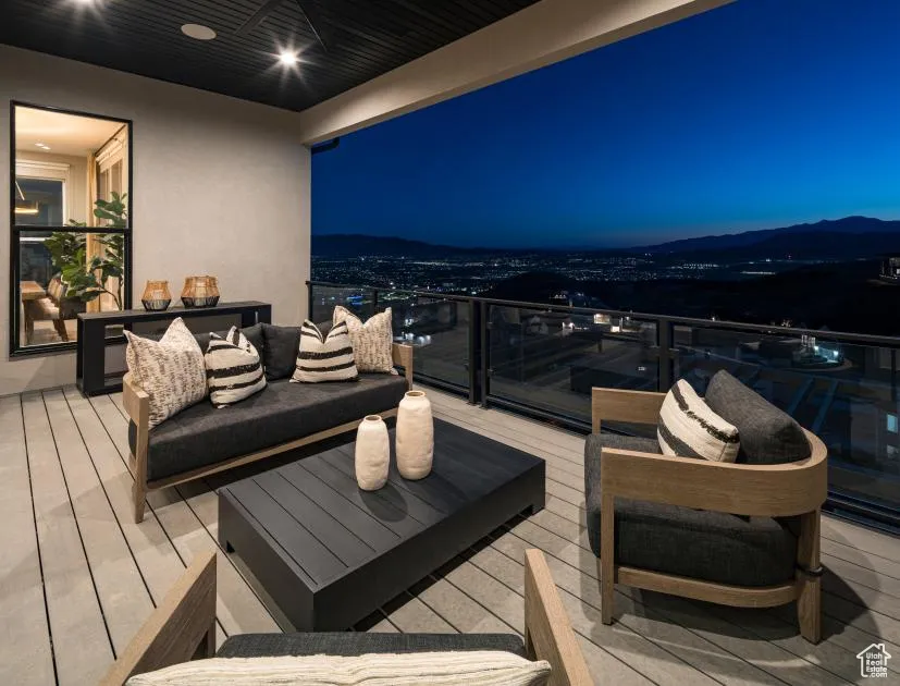 Wooden terrace with an outdoor living space and a patio area
