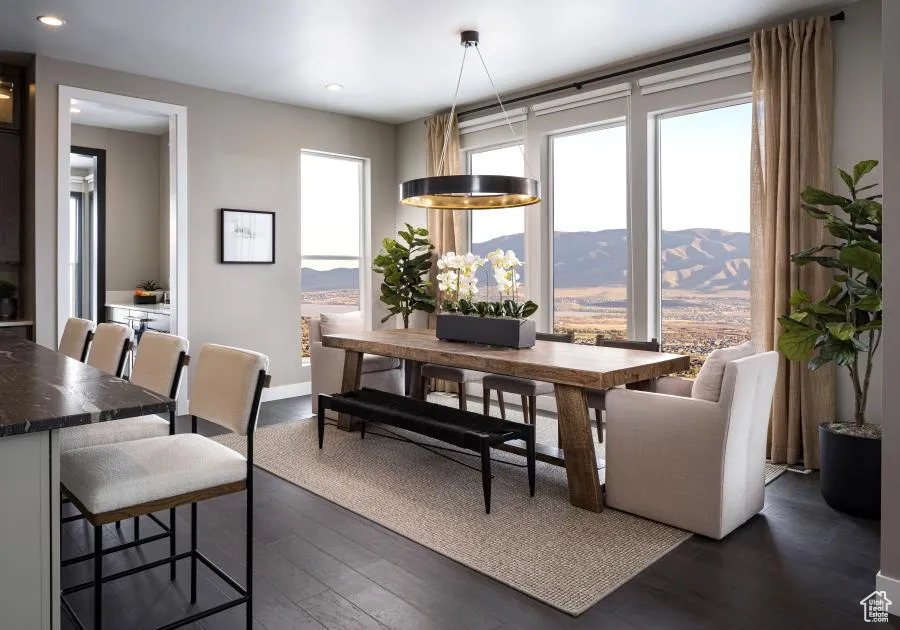 Dining room with dark wood-style floors, a mountain view, and recessed lighting