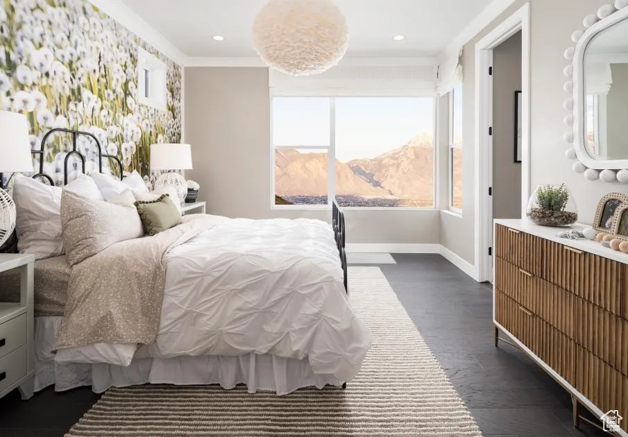 Bedroom with dark wood-style floors, crown molding, a mountain view, and recessed lighting