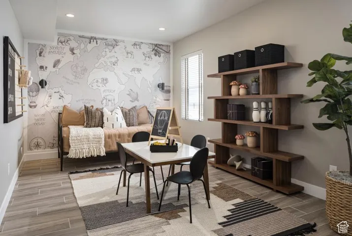 Sitting room with an office area, wood tiled floors, an accent wall, and recessed lighting