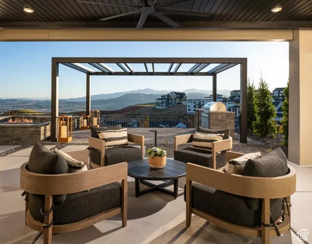 View of patio / terrace with a mountain view, a ceiling fan, exterior kitchen, an outdoor hangout area, and a pergola