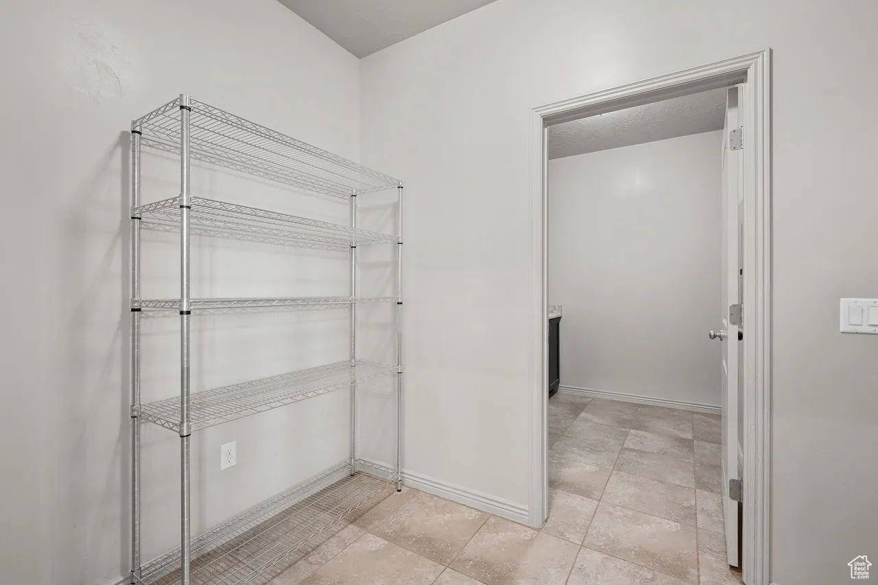 Bathroom featuring baseboards and light tile patterned flooring
