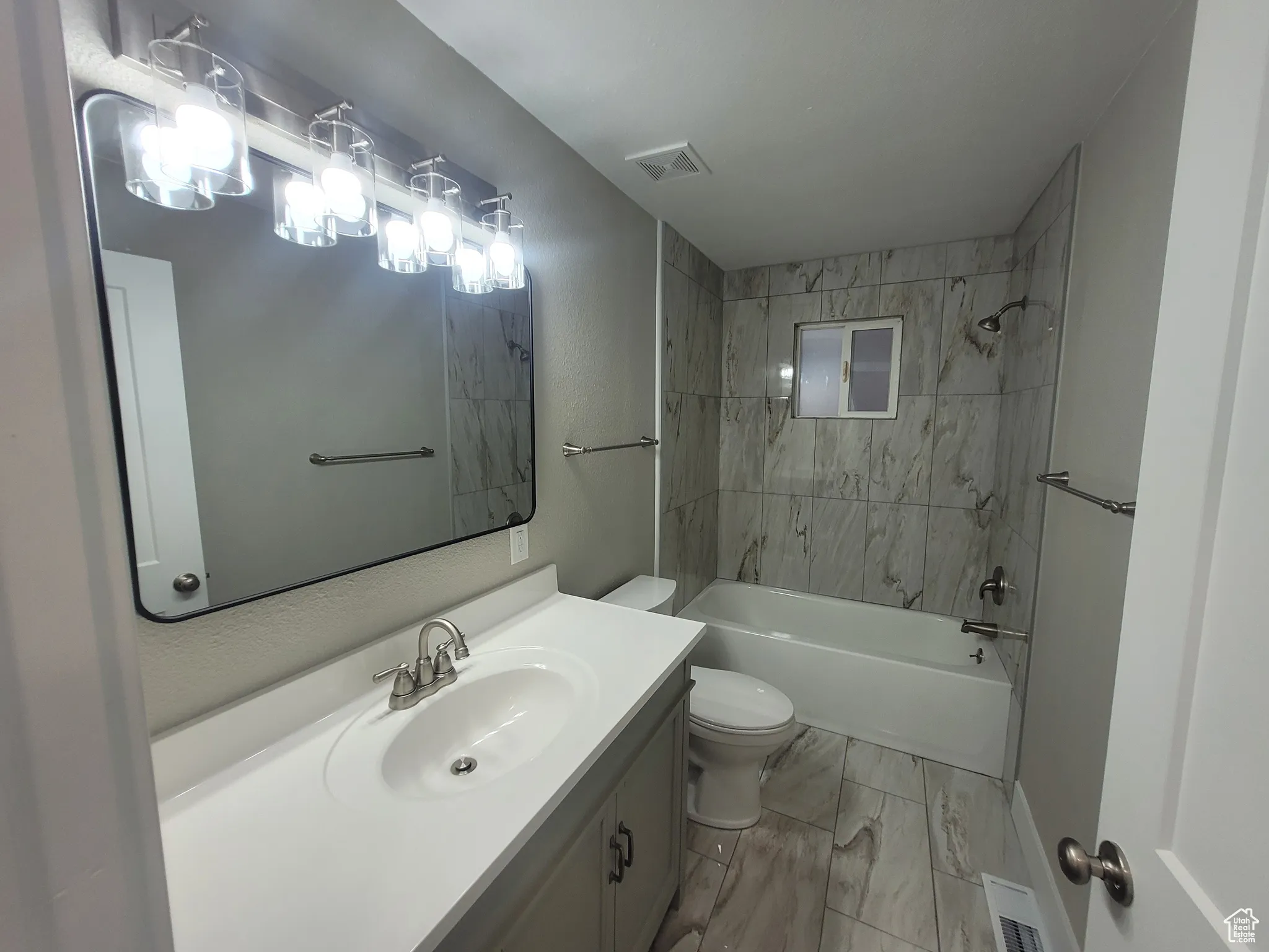 Bathroom featuring shower / bathtub combination and vanity