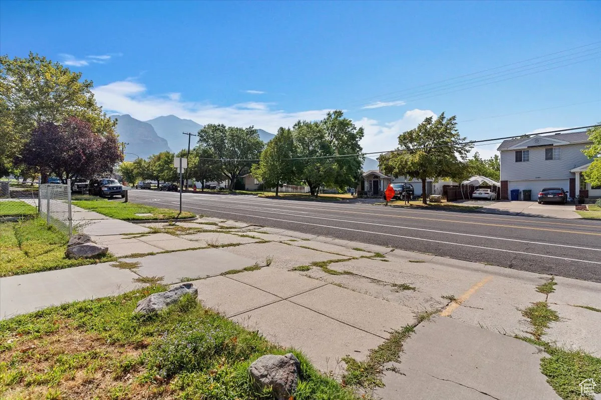 View of asphalt road featuring sidewalks