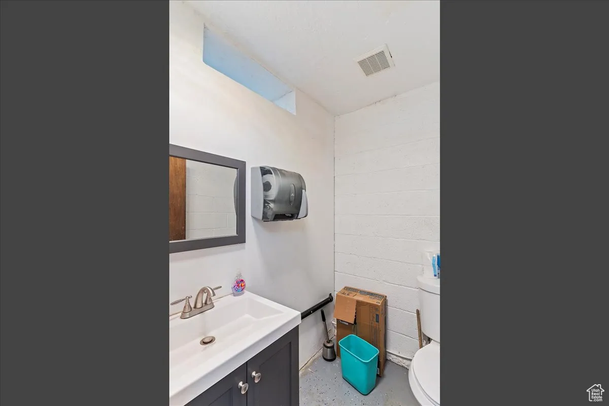 Bathroom with vanity and concrete block wall