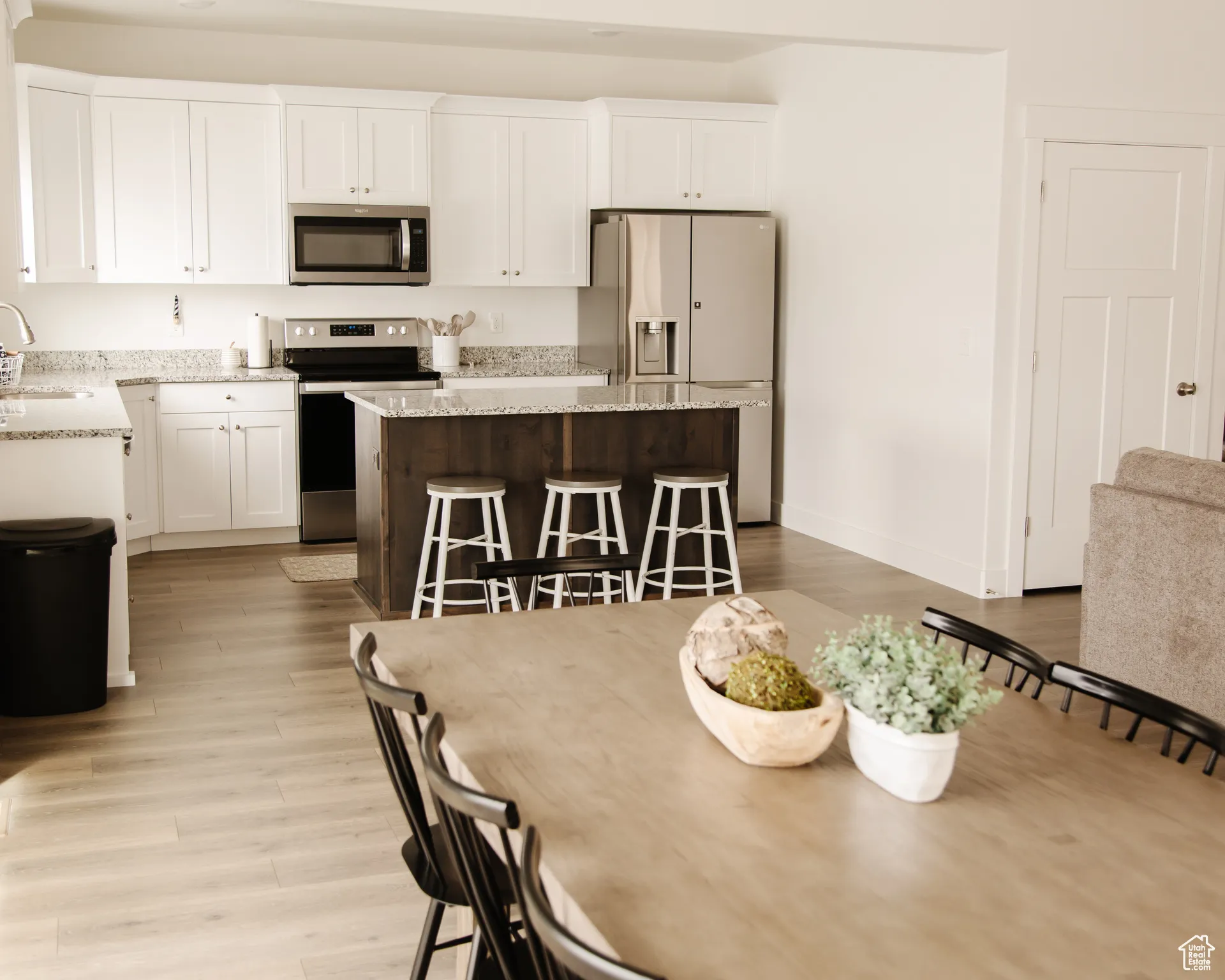 Dining area with light wood-type flooring and baseboards