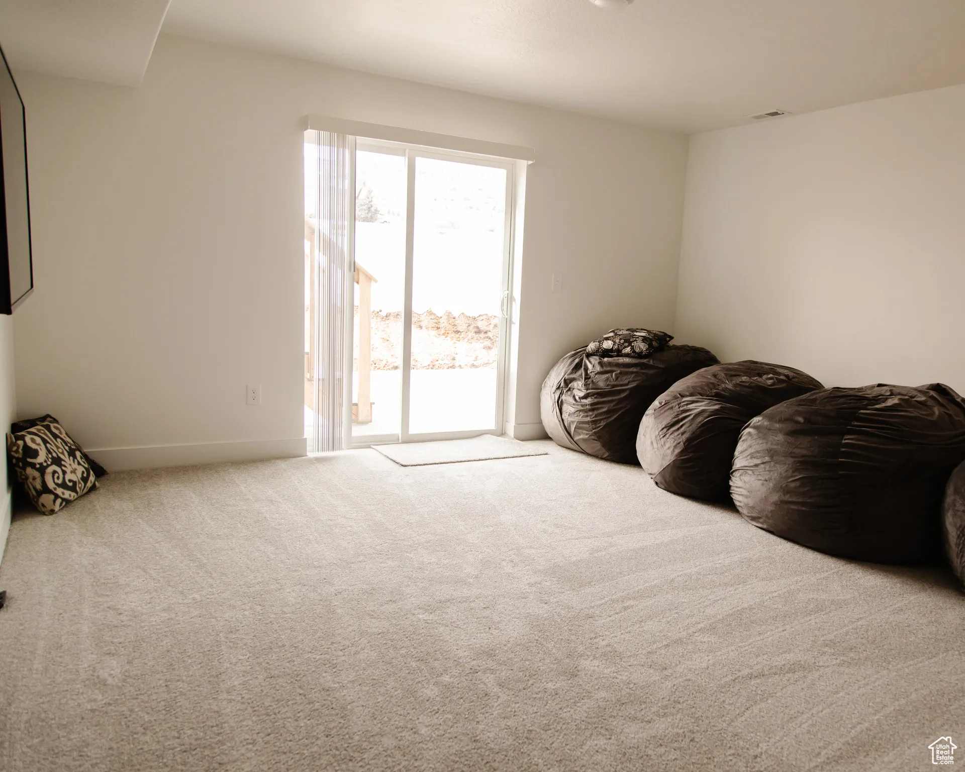 Sitting room with carpet floors and baseboards