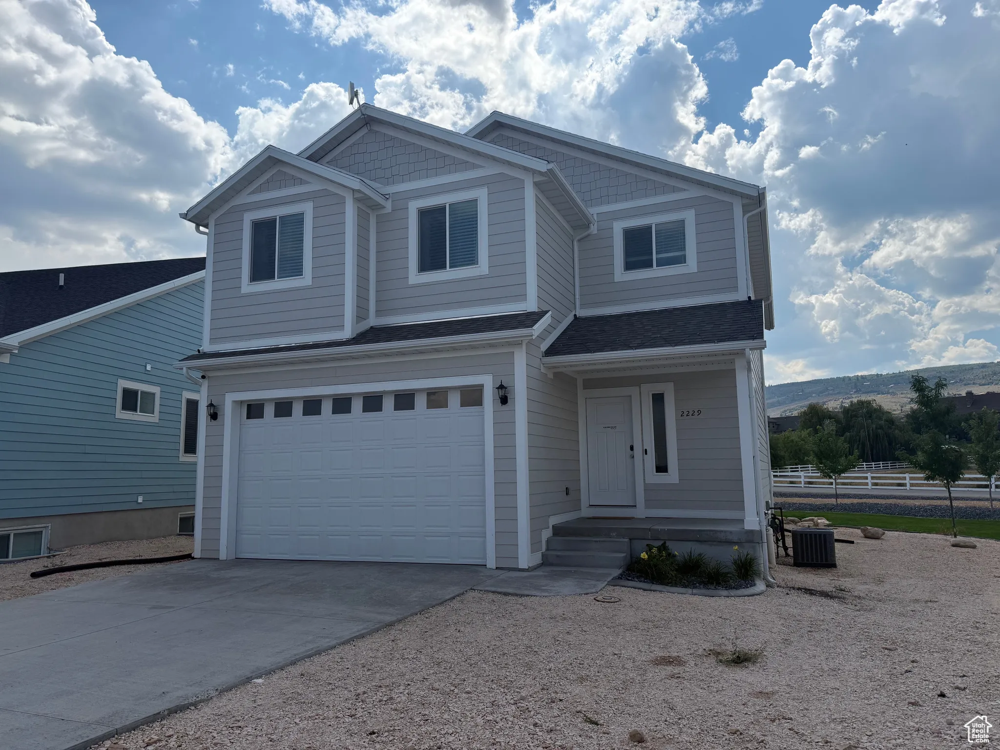 View of front of house featuring driveway and a garage